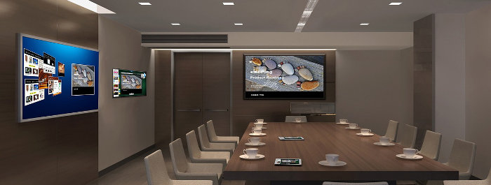 An office conference room with comfortable chairs, multiple large monitors, and a comfortable atmosphere