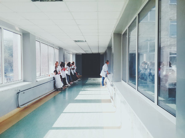 Hospital Hallway with Patients, Visitors, Nurses, and Doctor